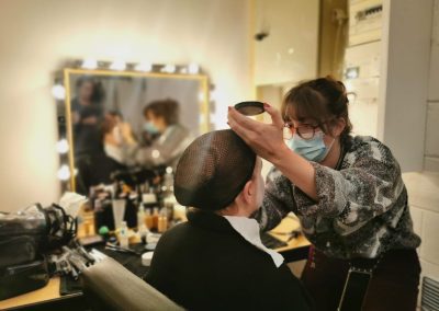 Makeup artist applying makeup to an actress