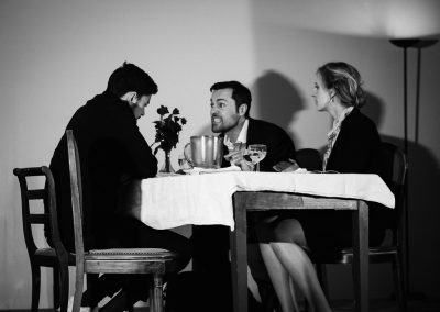 3 people at a table one man sits across from a woman and another man