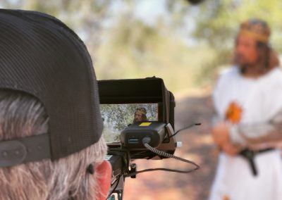 Camera man on set filming an actor